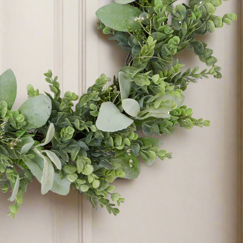 Close view of wreath created with replica eucalyptus and Lambs ear greenery.