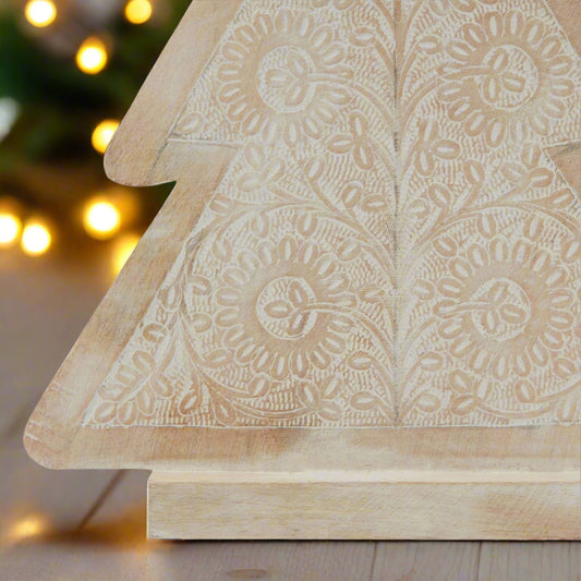 Close up of left corner f a Wooden Christmas tree ornament showcasing the intricate patterns detail.