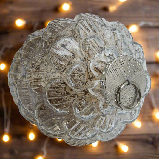 Decorative glass pine cone hanging decoration with intricate patterns and decorative stones.