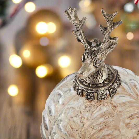 Decorative ombre glass bauble topped with ornamental stag head.