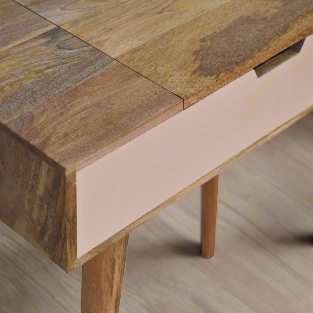 Close view of top left corner of cut-out hand painted mini dressing table, showing oak-ish finish and pink hand paint