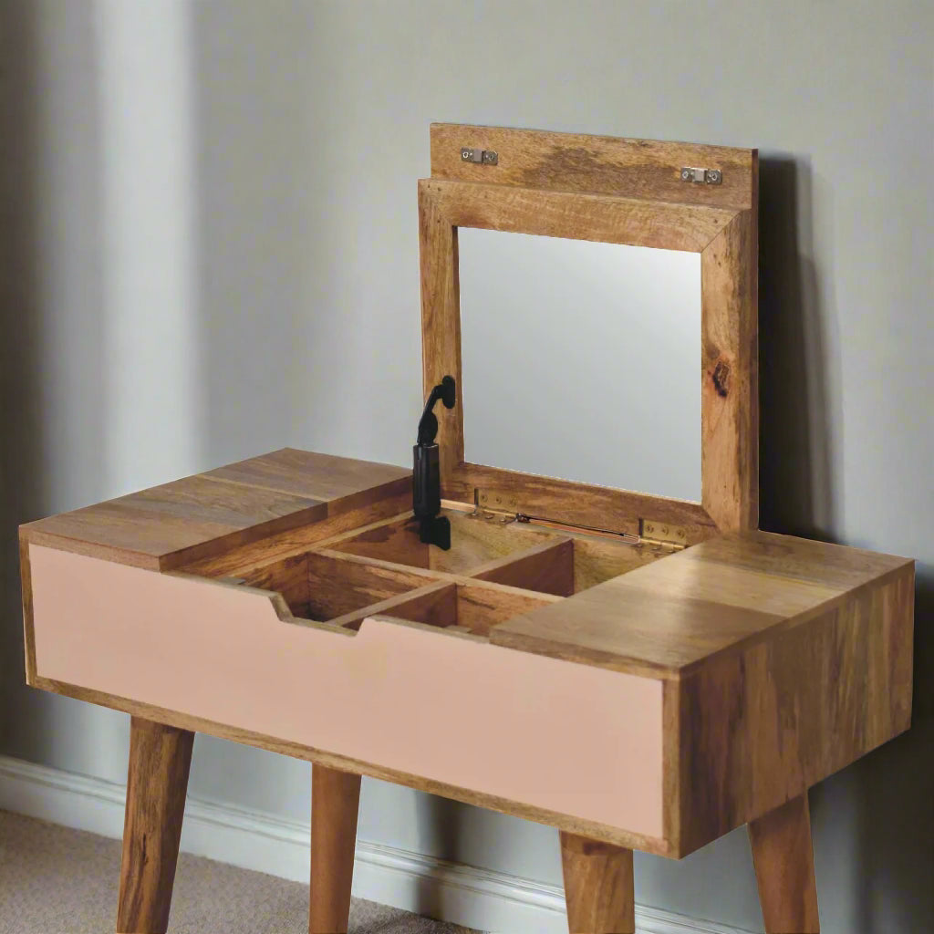 Close angle view of the cut out hand painted mini dressing table pink paint oakish-finish, showcasing the fold-up mirror open, revealing storage compartments.
