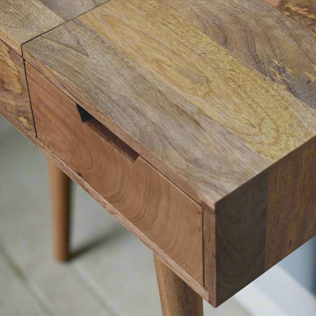 Close view of top right corner of cut-out natural dressing table, with oak-ish finish