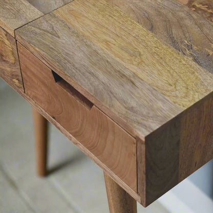 Close view of top right corner of cut-out natural dressing table, with oak-ish finish