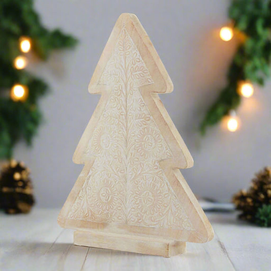 Large decorative wooden Christmas tree with embossed design with a festive background