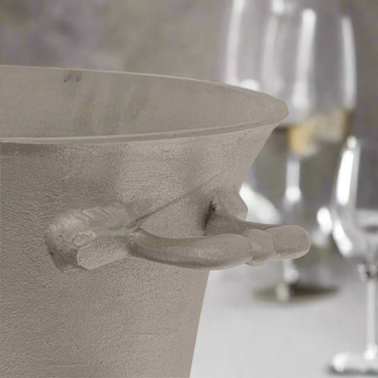 Close-up of the handle of a silver pewter champagne bucket