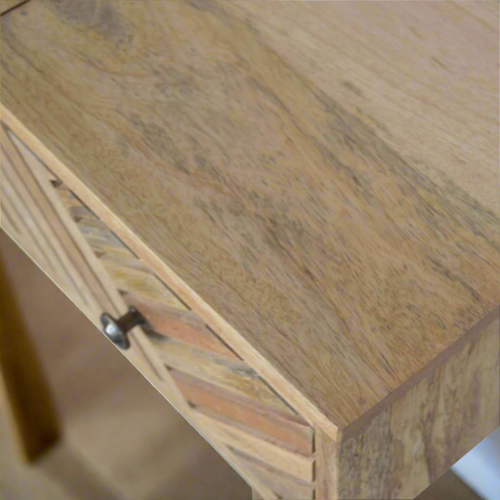 Lined carved dressing table, displaying wood grain of top left corner of table