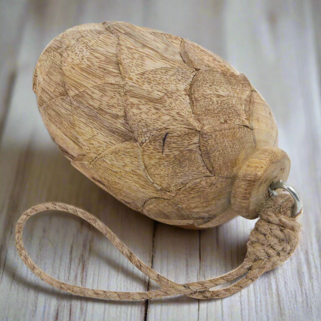 Close up view of wooden pine cone hanging decoration, showcasing the beautiful cone carvings