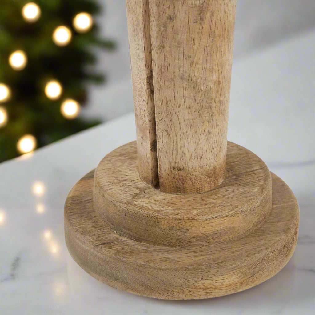 Bottom view of the wooden nutcracker figure displaying the good quality wood and sturdy round bottom stand.