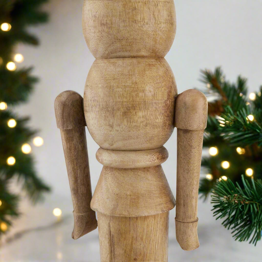 Close up view of Wooden nutcracker figure showcasing the middle body section and arms.