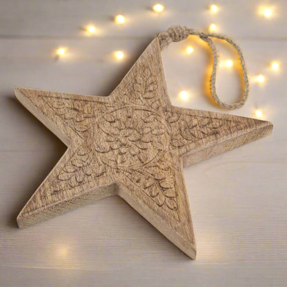 Wooden star hanging decoration placed on table, showcasing close up of intricate cut pattern and hanging twine, buy at Purple Flamingo UK