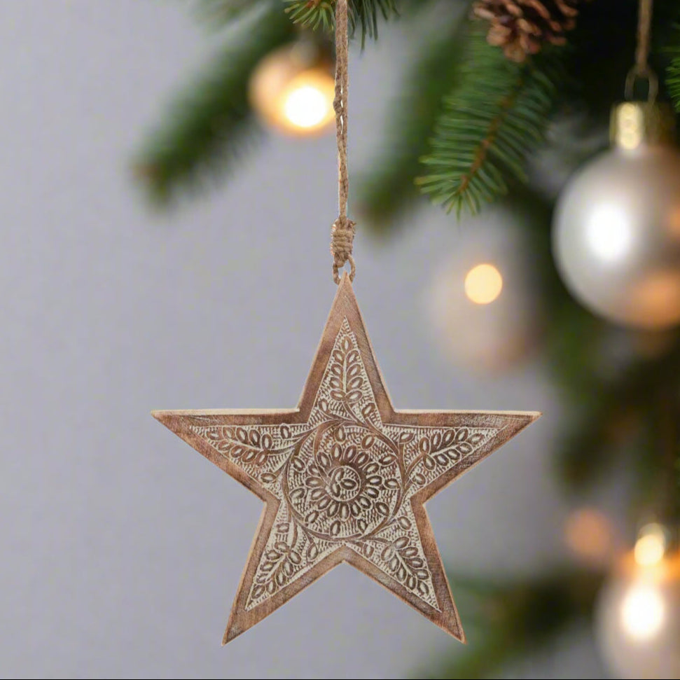 Wooden star hanging decoration displaying back view of intricately cut pattern and hanging twine, buy at Purple Flamingo UK