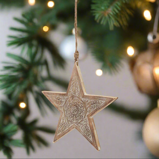 Wooden star hanging decoration displaying front view of intricately cut pattern and hanging twine, buy at Purple Flamingo UK