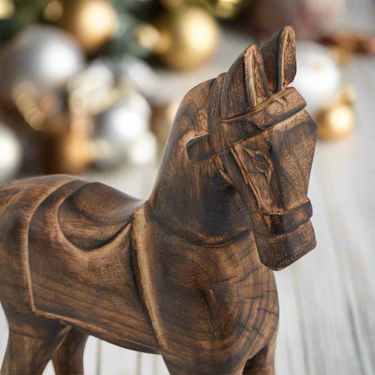 Close up view of a wooden rocking horse ornament displaying the detailed carving of the head and body, purchase at Purple Flamingo UK
