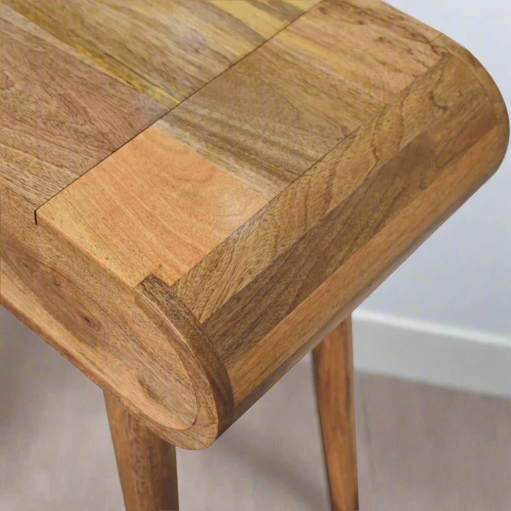 Elevated view showcasing the smooth rounded edges of the rounded mini dressing table, with oak-ish finish
