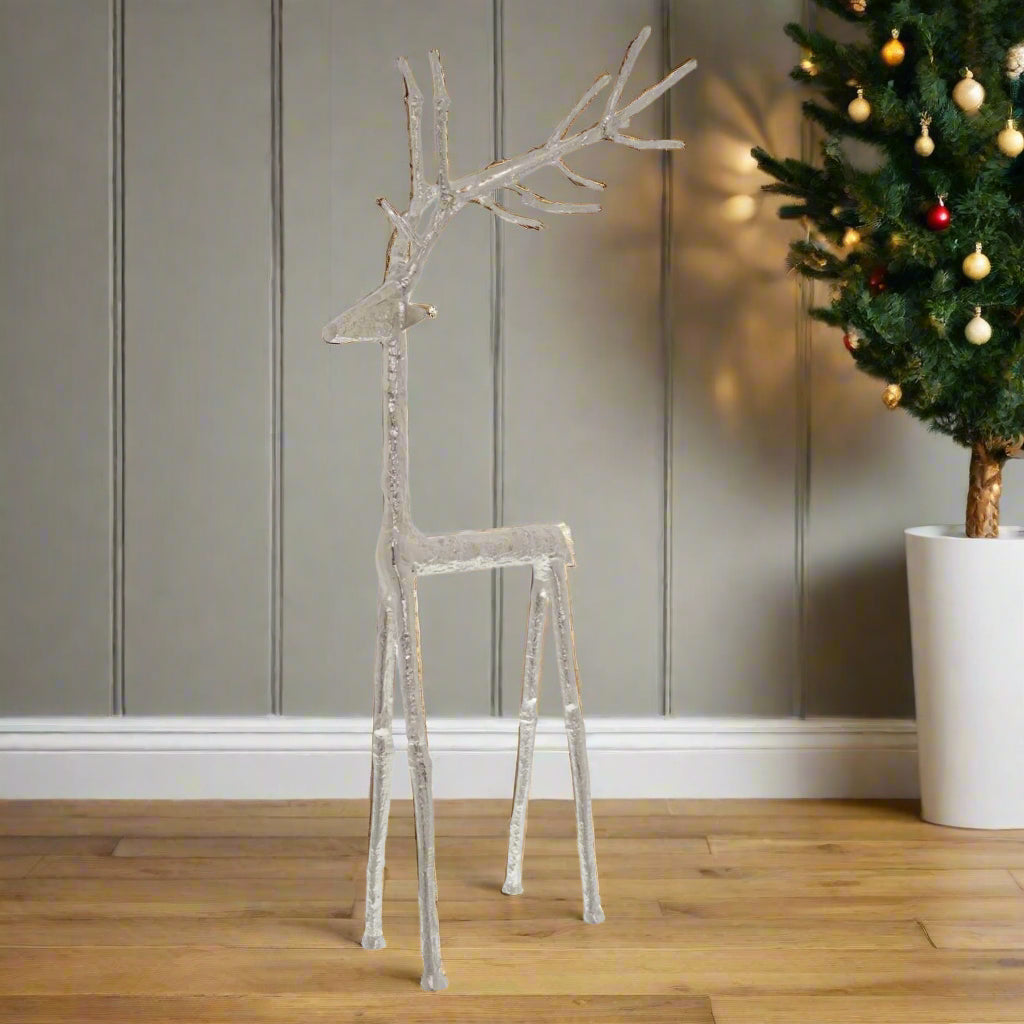 Very large majestic decorative stag figure floor standing ornament crafted intricately in silver toned metal, standing in a festive setting. Shop now at Purple Flamingo UK.