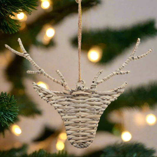 A reindeer head shaped hanging decoration, made from woven wicker hanging from a Christmas Tree. Enjoy a 20% multi-buy discount at Purple Flamingo UK