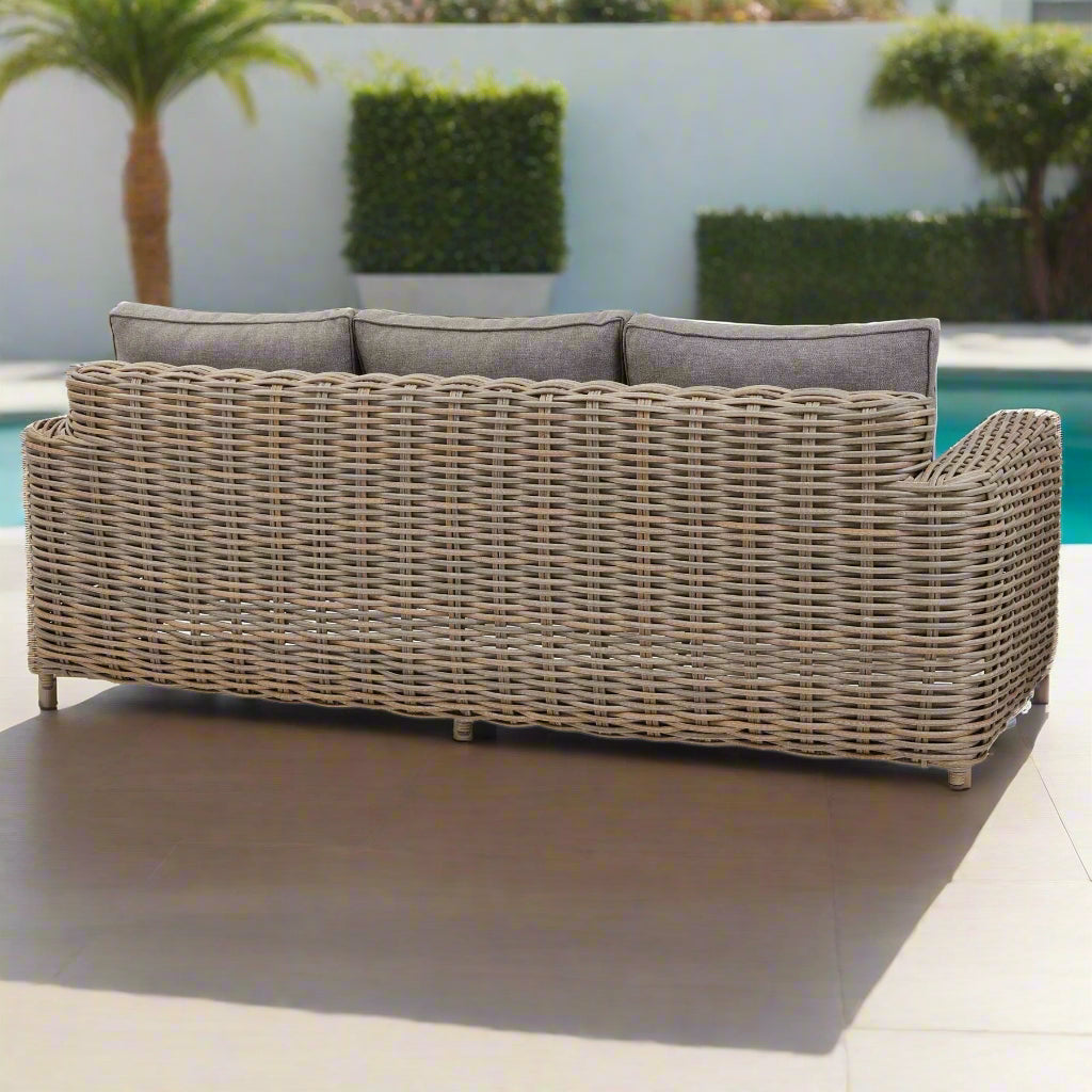 Back view of the Amalfi three-seater sofa, showing the wicker weave and edges of the Olefin cushions.
