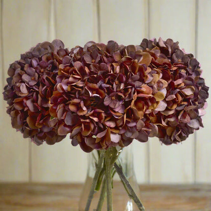 Bunch of Autumn Coffee Hydrangea stems in a clear glass vase – warm-toned artificial florals for autumnal home styling, from Purple Flamingo UK.