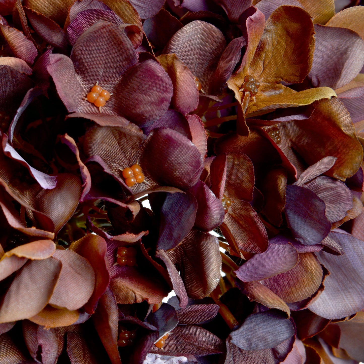 Close-up of lifelike hydrangea petals in deep coffee and chestnut tones, showcasing detail and realism in this artificial stem by Purple Flamingo UK.