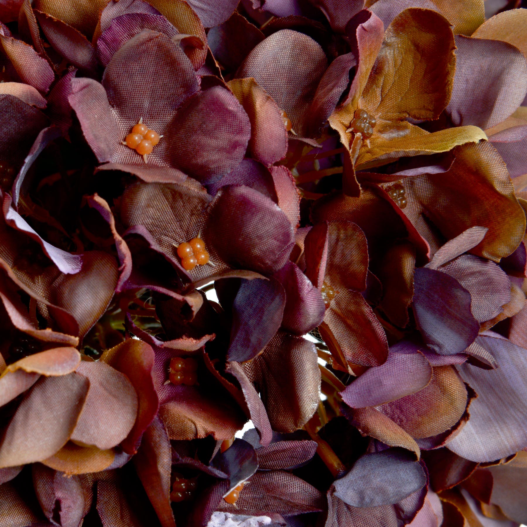 Close-up of lifelike hydrangea petals in deep coffee and chestnut tones, showcasing detail and realism in this artificial stem by Purple Flamingo UK.