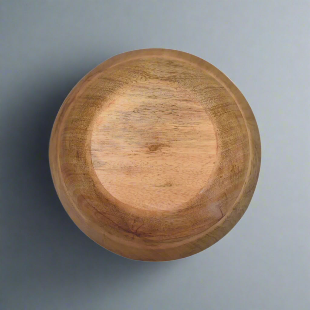 Aerial view of an upside-down black and white flower bowl, showing the wooden grain.