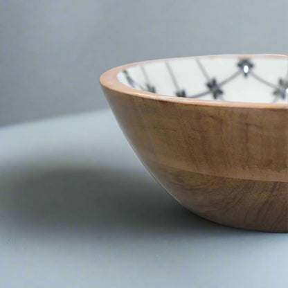 Close-up shot of the side of one bowl, showing the wooden pattern outside and part of the flower pattern inside.