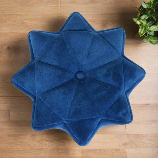 Top-down view of the blue velvet star footstool, clearly showing its distinctive star shape and central button detail.