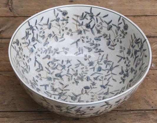 Top-down view showing the delicate ditsy floral pattern inside the ceramic bowl, emphasizing the detailed craftsmanship and smooth finish.