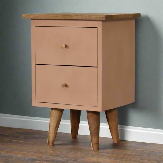 Side view of the blush pink hand-painted bedside table, showcasing its front, right side, four legs