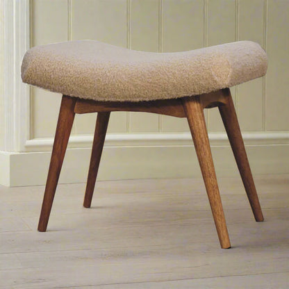 Angled view of the Boucle Cream Curve Stool, clearly showing all four Nordic style solid mango wood legs and the curved seat.