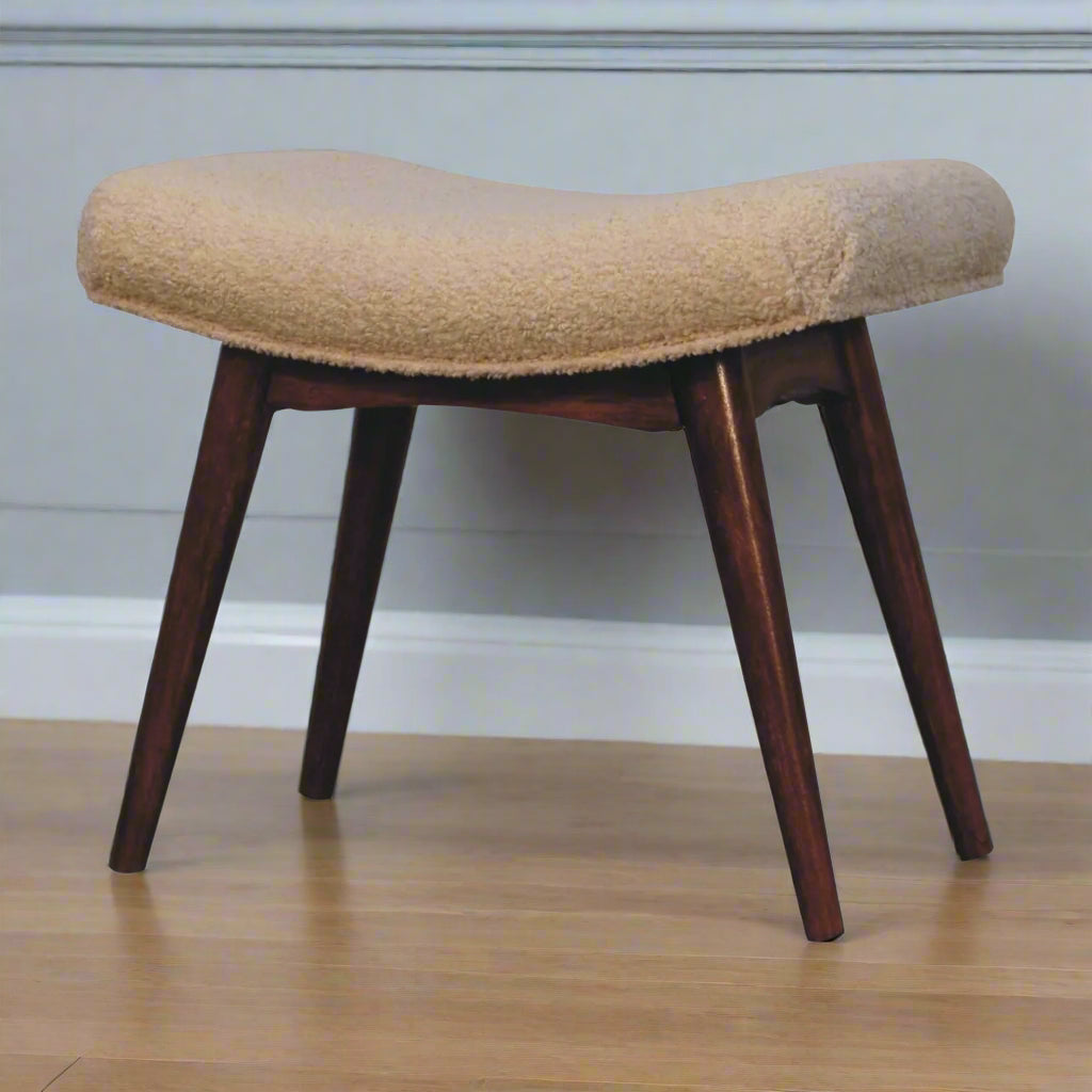 Angled view of the Boucle Cream Curve Stool, displaying its comfortable cream boucle seat and all four Nordic style legs.