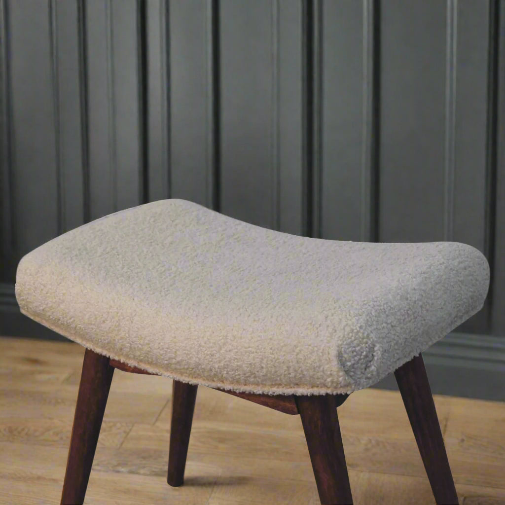 Elevated angled view of the Boucle Cream Curve Stool, offering a comprehensive look at its design and shape.