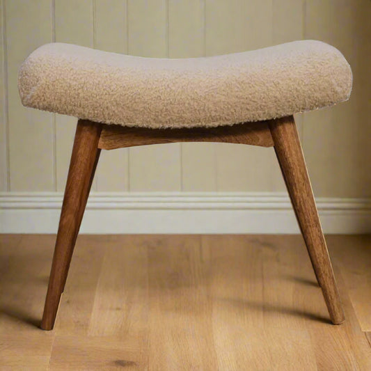 Front view of the Boucle Cream Curve Stool, showcasing its cream boucle upholstered seat and natural oak-ish finished Nordic style legs.