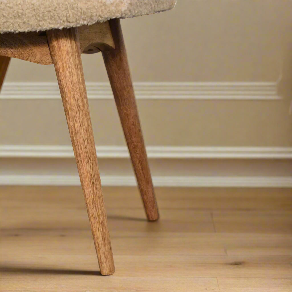 Detailed view of the Nordic style legs of the Boucle Cream Curve Stool, showcasing their design and oak-ish finish.