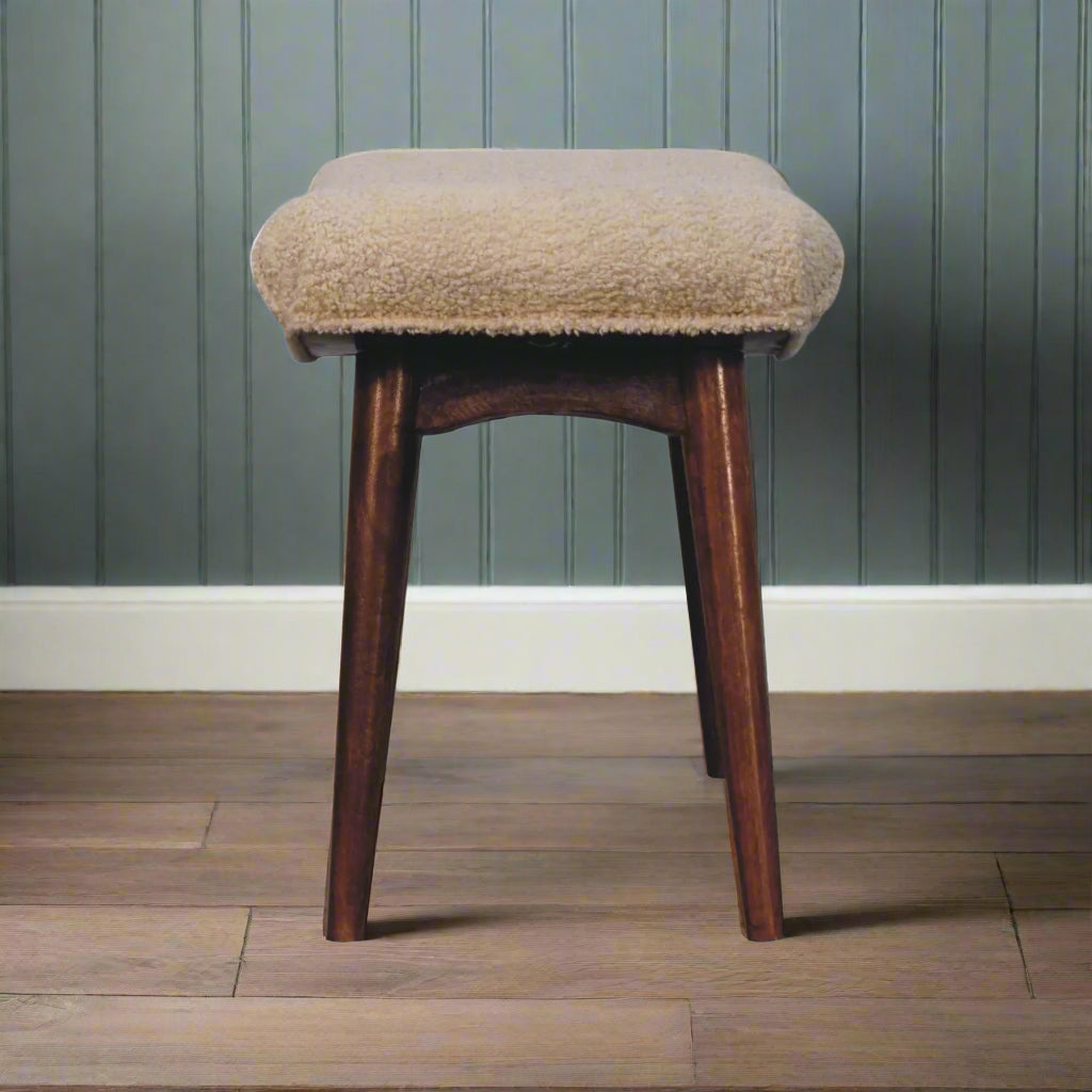 Full side view of the Boucle Cream Curve Stool, displaying its elegant curved silhouette.