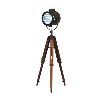 Brass Antique Tripod Fold Spotlight Floor Lamp with its light on, demonstrating its functional illumination and statement presence.
