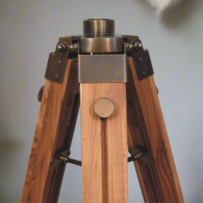 Close-up shot of the point where the tripod stand is attached to the Brass Caged Spotlight Floor Lamp, with the lamp detached.