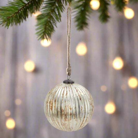 A beautiful burnished glass fluted Christmas bauble with a shimmering metallic finish and ribbed texture, perfect for elegant festive tree decorations.