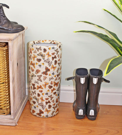Butterfly ceramic umbrella and stick stand styled in a hallway next to a pair of black boots on wooden floor – Purple Flamingo UK