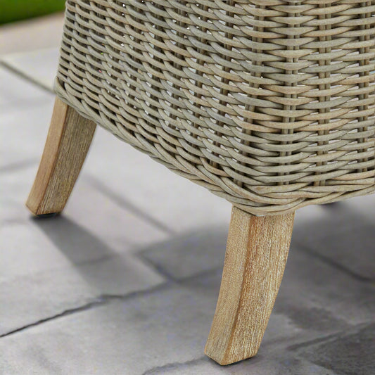 Angled close-up of the Capri Dining Chair, highlighting the detailed acacia wood feet and woven structure.