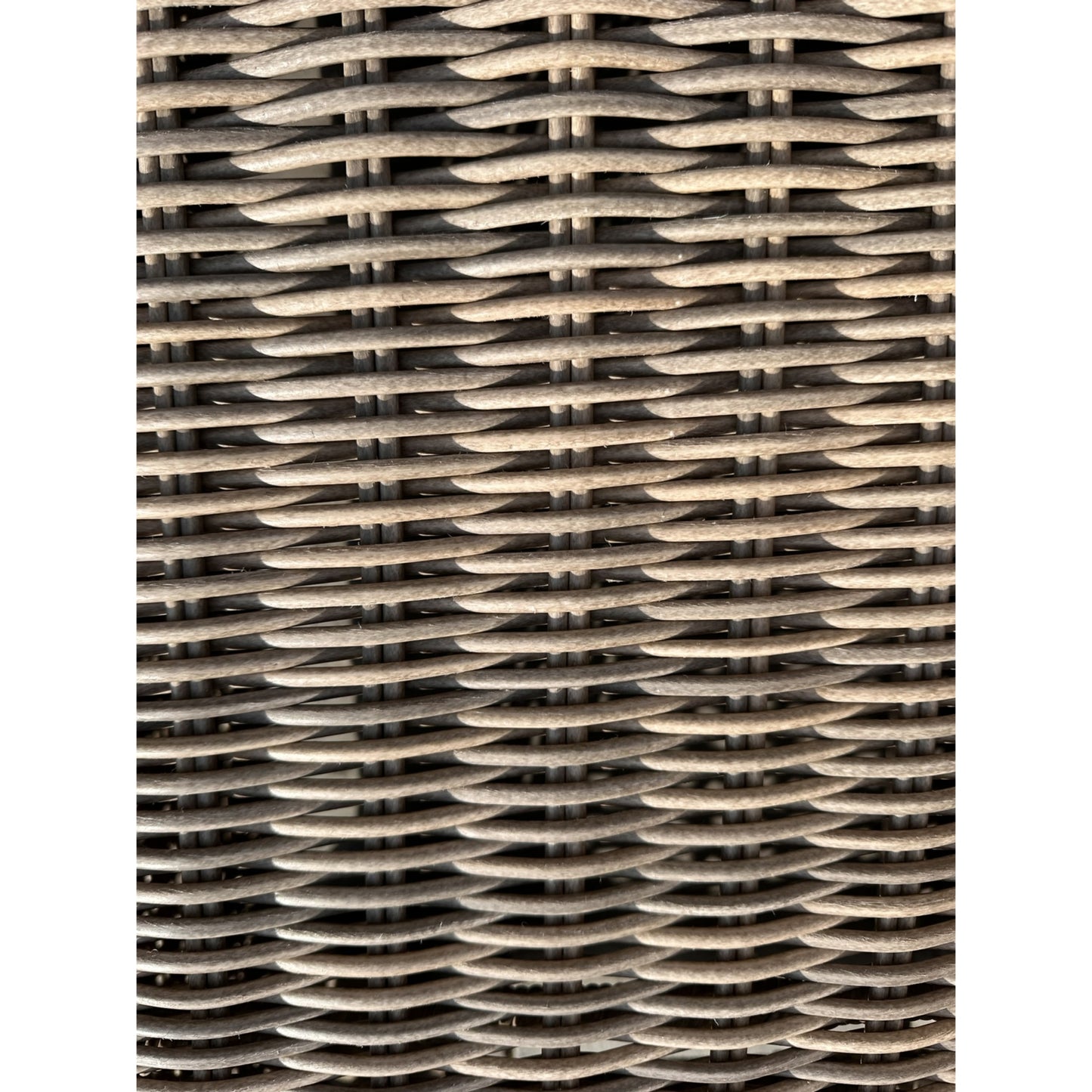 A zoom on to the wicker weave that characterizes the large corner set and its coffee table.