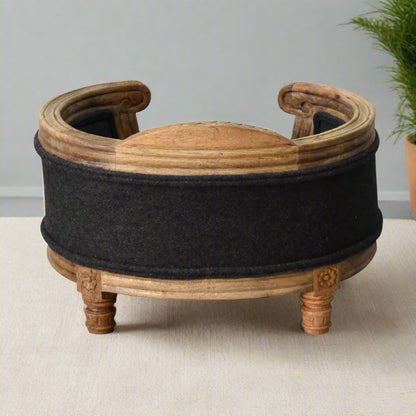 Rear view of the elevated pet bed, highlighting the curved wooden back and supportive cushioned seat in deep grey tweed.