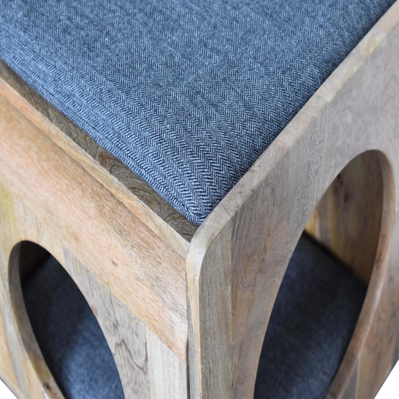 Detailed close-up of the black tweed seat pad and corner craftsmanship, highlighting the refined joinery of the wooden pet furniture.