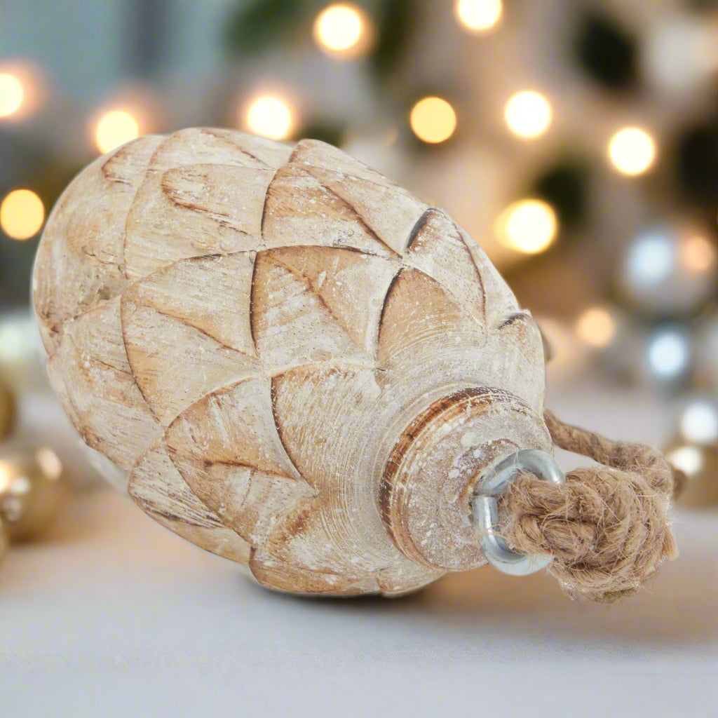 close up view of a pine cone decoration showcasing the intricate detailing and durable hanging twine.