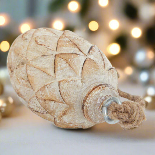 close up view of a pine cone decoration showcasing the intricate detailing and durable hanging twine.