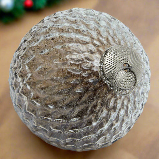 Close-up of a coffee ombre detailed bauble, highlighting its intricate raised patterns and smooth colour transition on the textured glass.