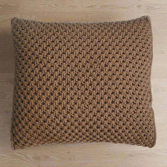 isolated coffee woven cushion on a wooden surface.