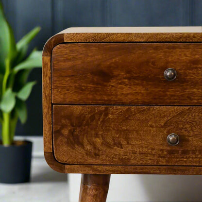 Close-up of the two drawers on the curved chestnut bedside table, highlighting the natural wood grain and simple knob handles.