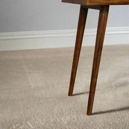 Close focus on Nordic leg design and chestnut finish
